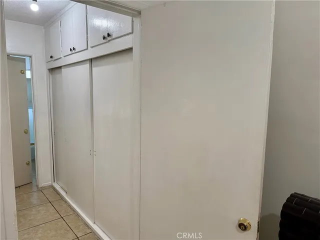 a kitchen with white cabinets and a fireplace