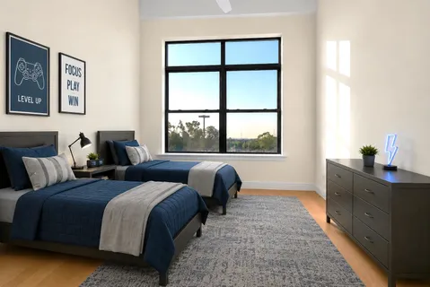 a bedroom with two beds and a large window