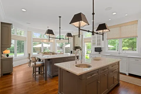 a kitchen with stainless steel appliances granite countertop a sink a stove and a wooden floors