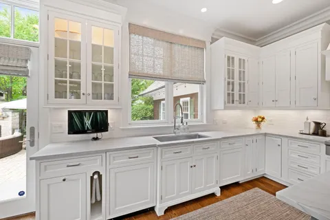 a living room with fireplace furniture and a large window