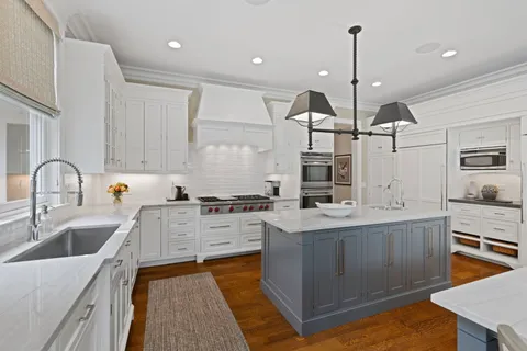 a living room with furniture a fireplace and a large window
