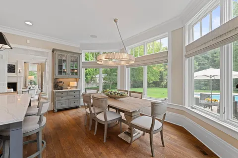 wooden floor with white cabinet and mirror