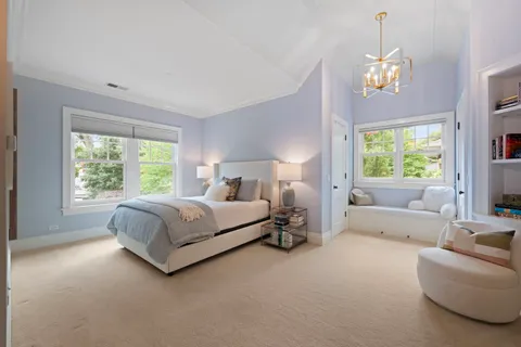 a kitchen with stainless steel appliances kitchen island granite countertop a table chairs and a refrigerator