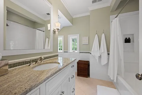 a view of a patio with couches table and chairs under an umbrella