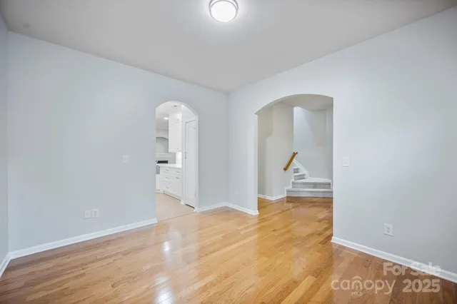 a view of a room with wooden floor and bathroom view
