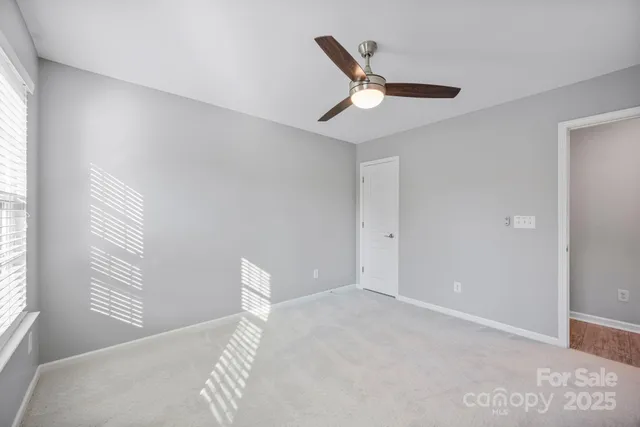 a view of a livingroom with a ceiling fan and window