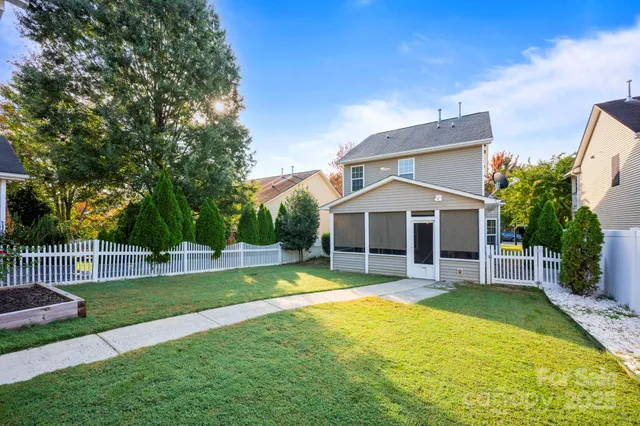a view of a house with a backyard and a small yard