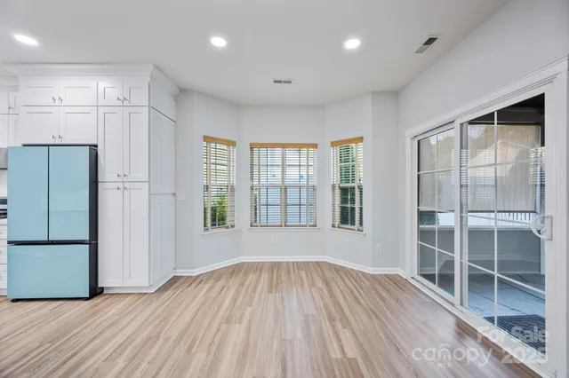 a view of wooden floor and windows in a room