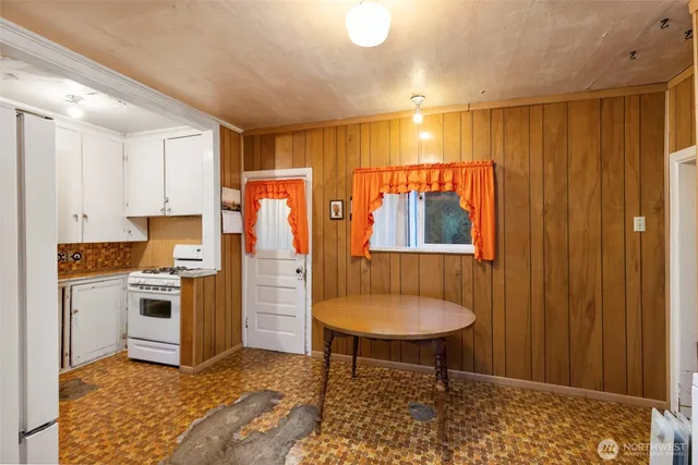 a kitchen with stainless steel appliances granite countertop a stove a refrigerator and a sink