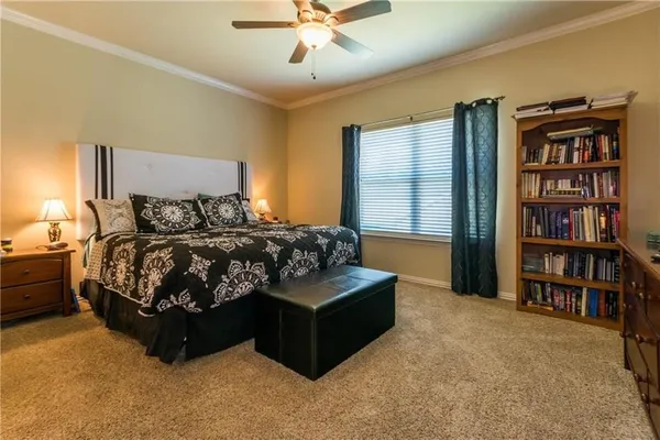 a bedroom with a bed window and a book shelf