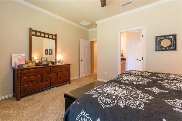 a bedroom with a bed and a mirror on dresser