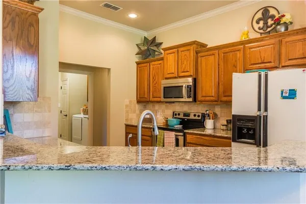 a kitchen with granite countertop a sink and a stove top oven