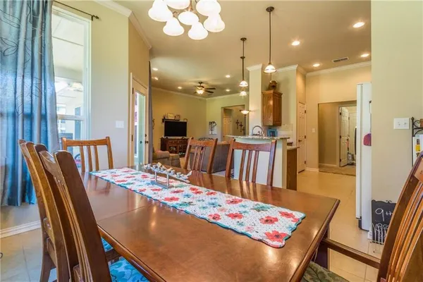a large kitchen with a table and chairs