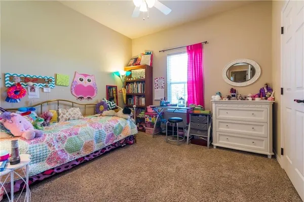 a bedroom with a bed closet and a baby crib
