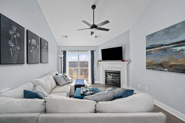 a living room with furniture fireplace and flat screen tv