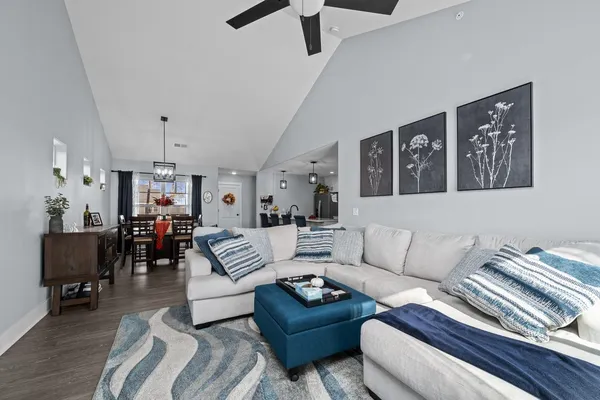 a living room with furniture and wooden floor