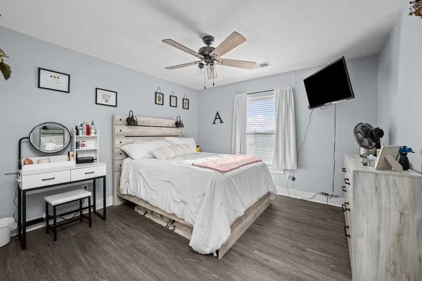 a bedroom with a bed and a flat screen tv