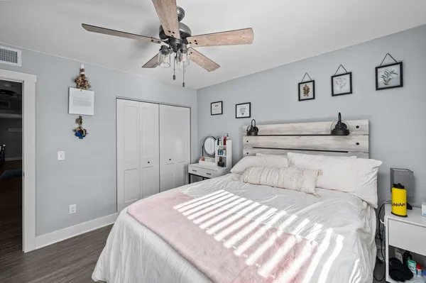 a bedroom with a bed and wooden floor