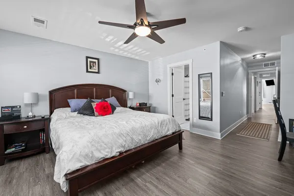 a bedroom with a bed and a chandelier