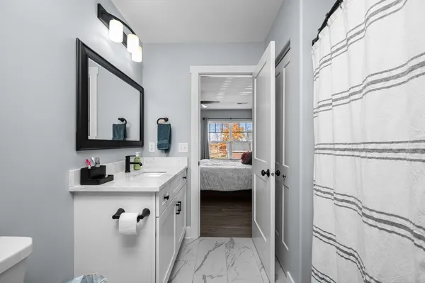 a en suite bathroom with a toilet sink and mirror