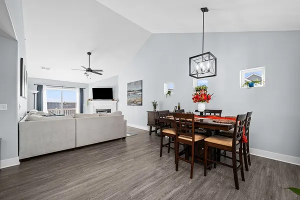 a view of a dining room with furniture wooden floor and a chandelier
