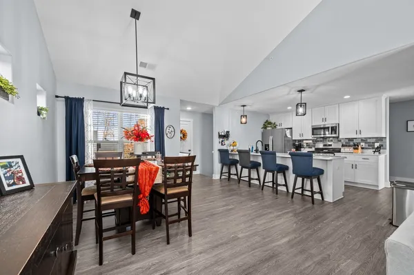 a view of a dining room with furniture and wooden floor