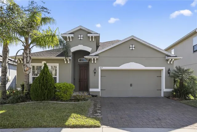 a view of a house with a yard and garage