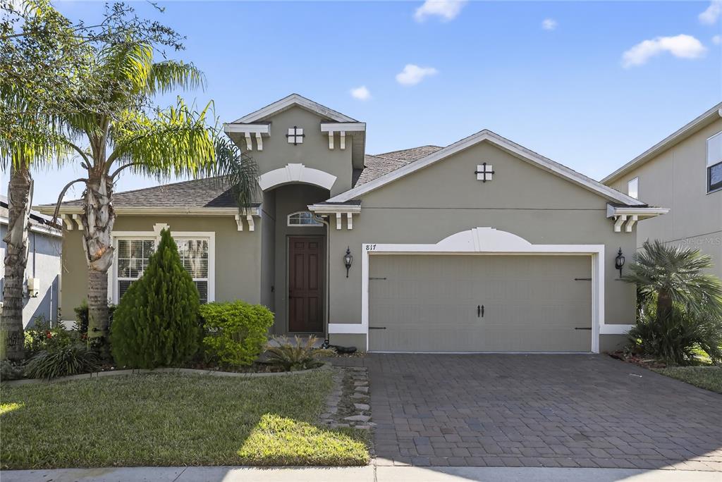 817 Dusty Pine Drive Ocoee, FL 34761 - Photo 2 of 16 a view of a house with a yard and garage