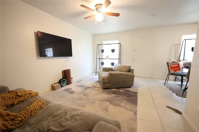 a view of a livingroom with furniture and a chandelier fan
