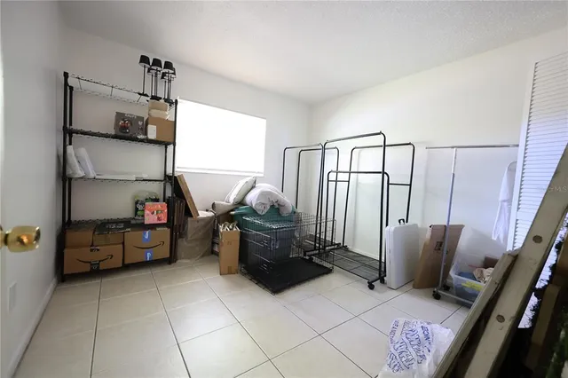 a bedroom with a bed and a dresser with window