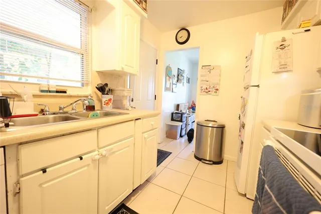 a kitchen with a sink stove and refrigerator