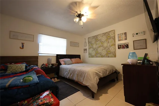 a room with a bed and a flat screen tv