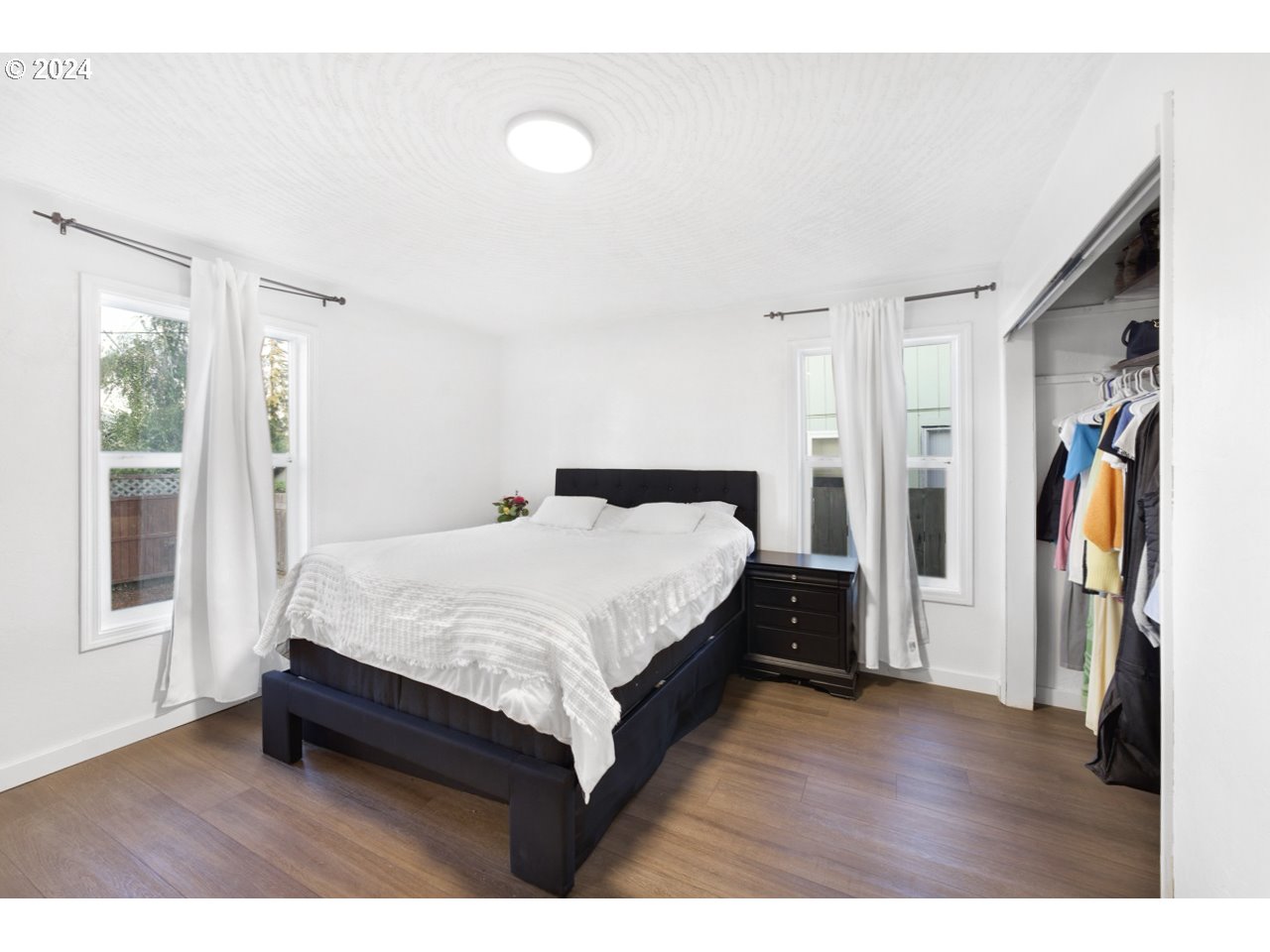 6988 Bluebelle Way Springfield, OR 97478 - Photo 12 of 28 a bedroom with a bed and a walk in closet