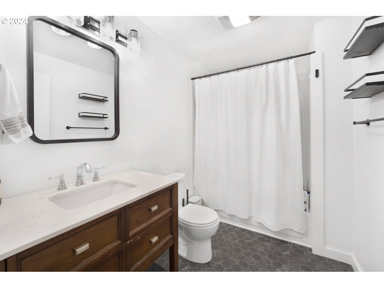 6988 Bluebelle Way Springfield, OR 97478 - Photo 16 of 28 a bathroom with a sink a toilet and a mirror
