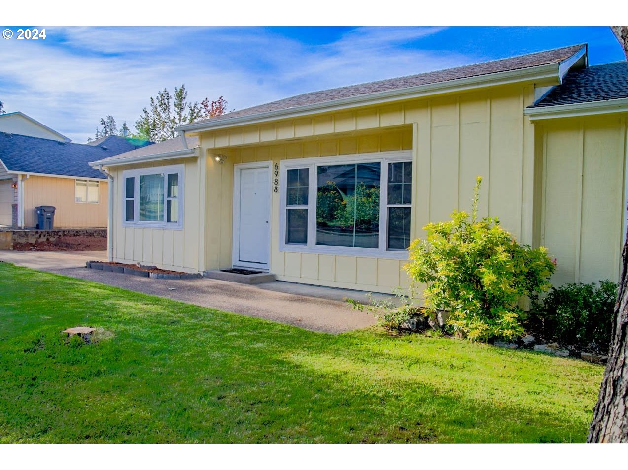 6988 Bluebelle Way Springfield, OR 97478 - Photo 2 of 28 a view of an house with backyard space and garden