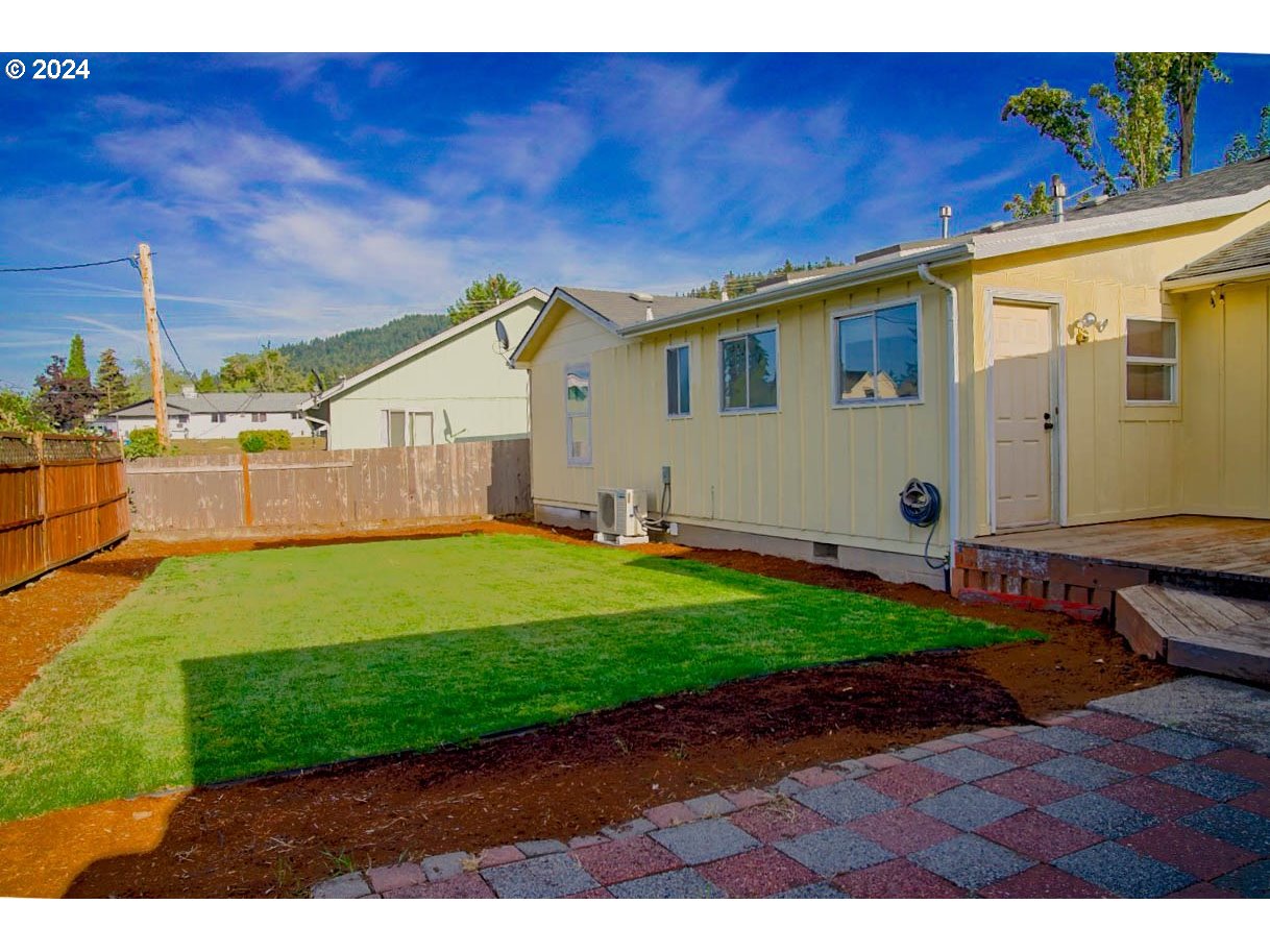 6988 Bluebelle Way Springfield, OR 97478 - Photo 21 of 28 a front view of a house with a garden