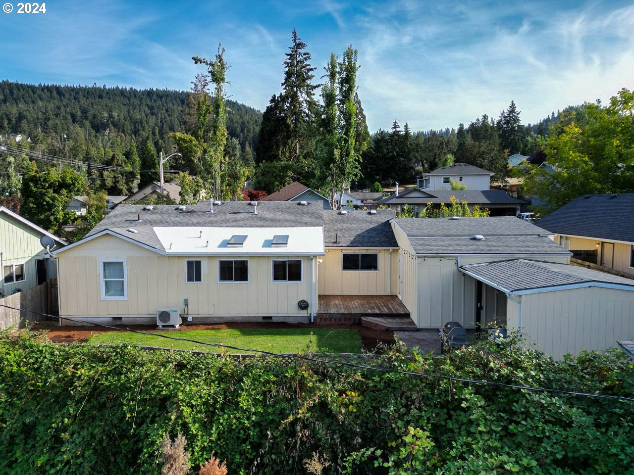 6988 Bluebelle Way Springfield, OR 97478 - Photo 27 of 28 an aerial view of a house with a yard and tree s
