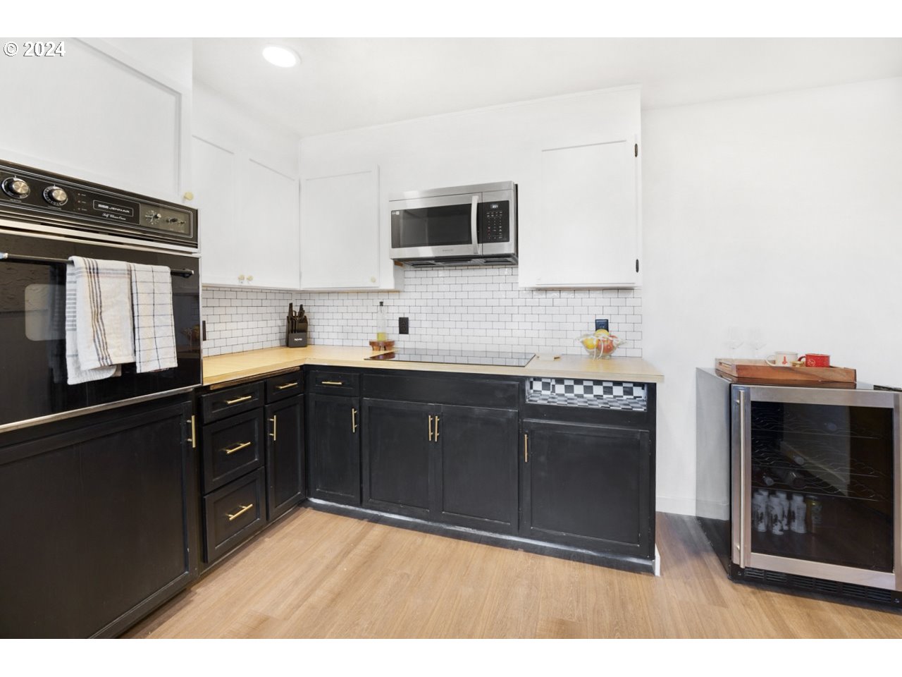 6988 Bluebelle Way Springfield, OR 97478 - Photo 5 of 28 a kitchen with stainless steel appliances granite countertop a stove a sink and a microwave
