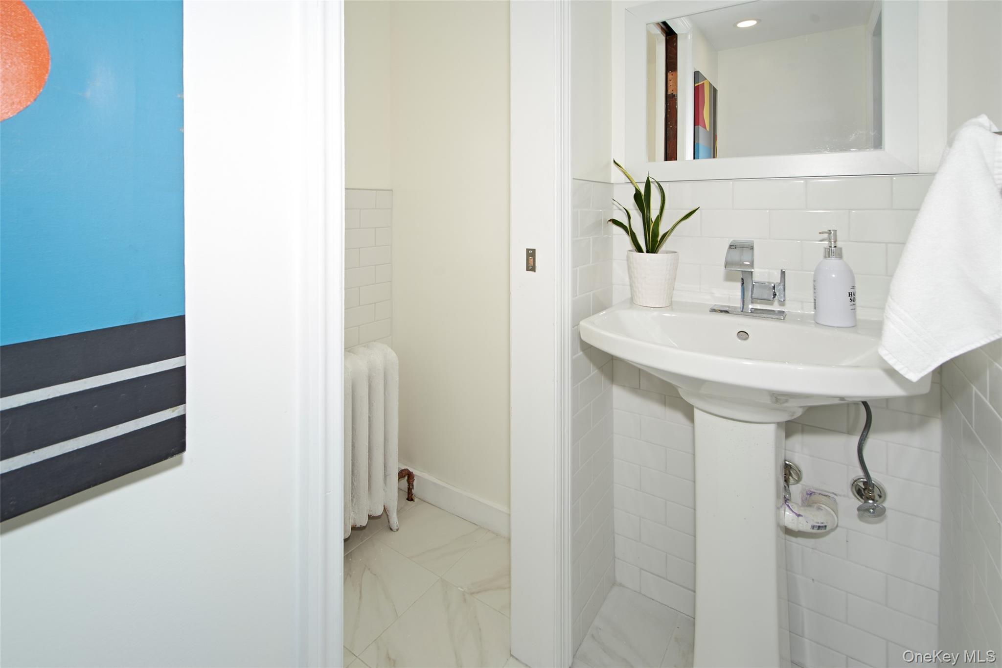 2 Byworth Road New Rochelle, NY 10804 - Photo 23 of 31 Bathroom with radiator heating unit, tile walls, and marble look tile flooring