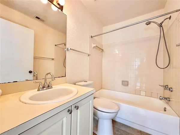 a bathroom with a sink a toilet and a bathtub