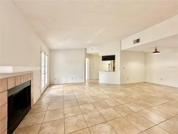 a view of an empty room with a fireplace