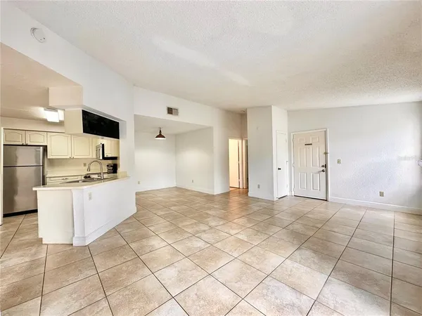 a large white kitchen with a stove a sink dishwasher and a refrigerator