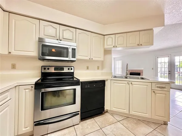 a kitchen with cabinets stainless steel appliances and a sink