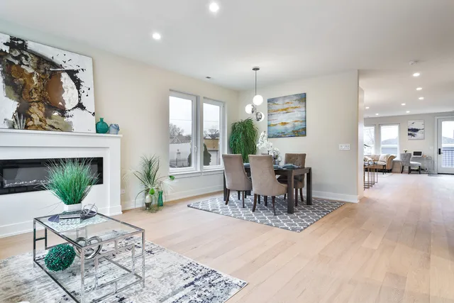 a dining room with furniture a floor to ceiling window and potted plants