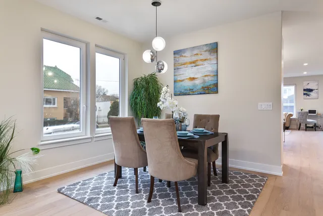 a dining room with furniture a rug and a chandelier