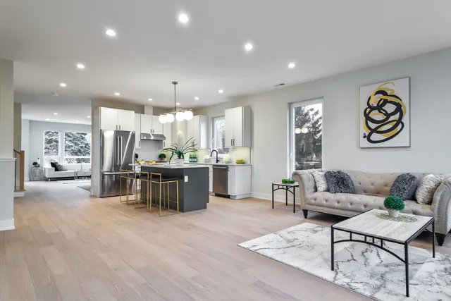 a living room with furniture and kitchen view