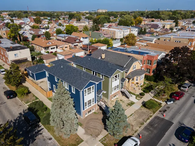 an aerial view of residential houses with outdoor space