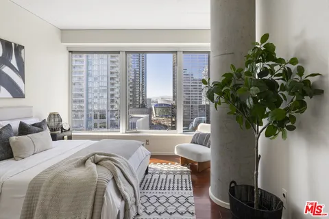 a bedroom with furniture and a potted plant