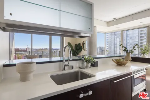 a kitchen with a sink and a large window