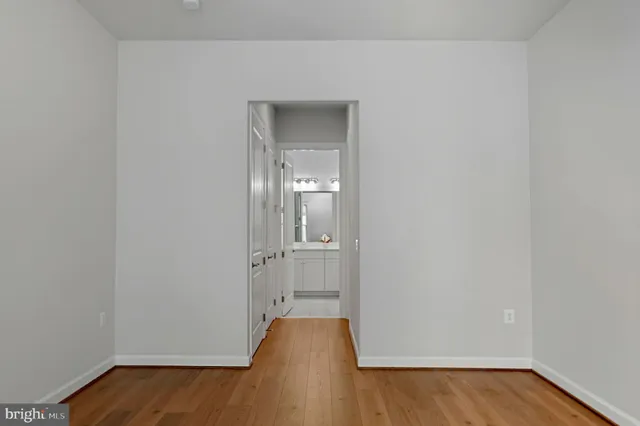 a view of a room with wooden floor